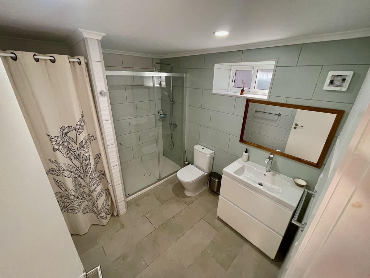 Full bathroom at Casa Tarapacana with walk-in shower, vanity, and mirror
