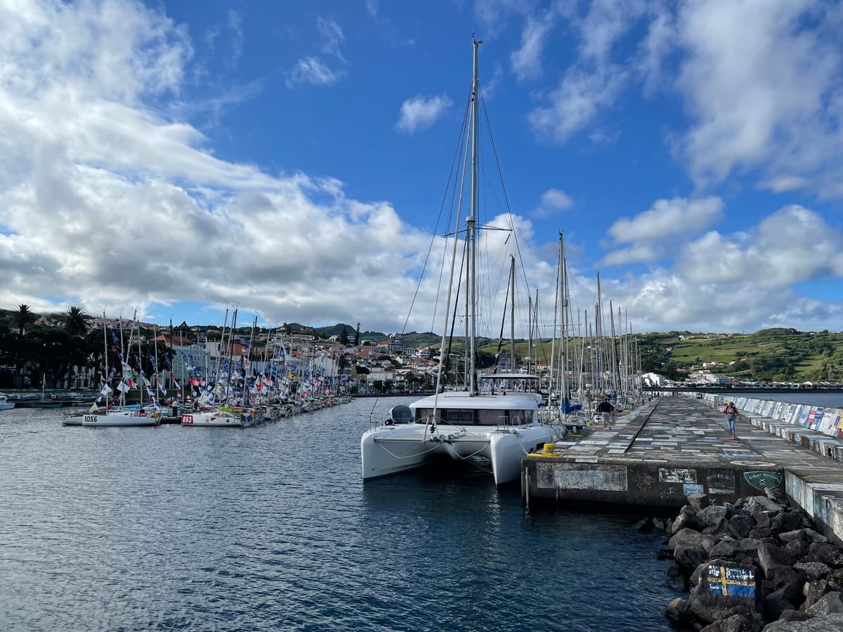 Sailboats in Horta marina under a blue sky
