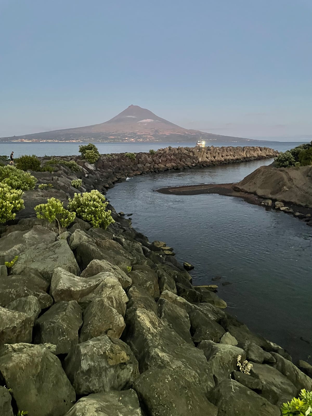 Mount Pico rising across the channel above the Porto Pim breakwater