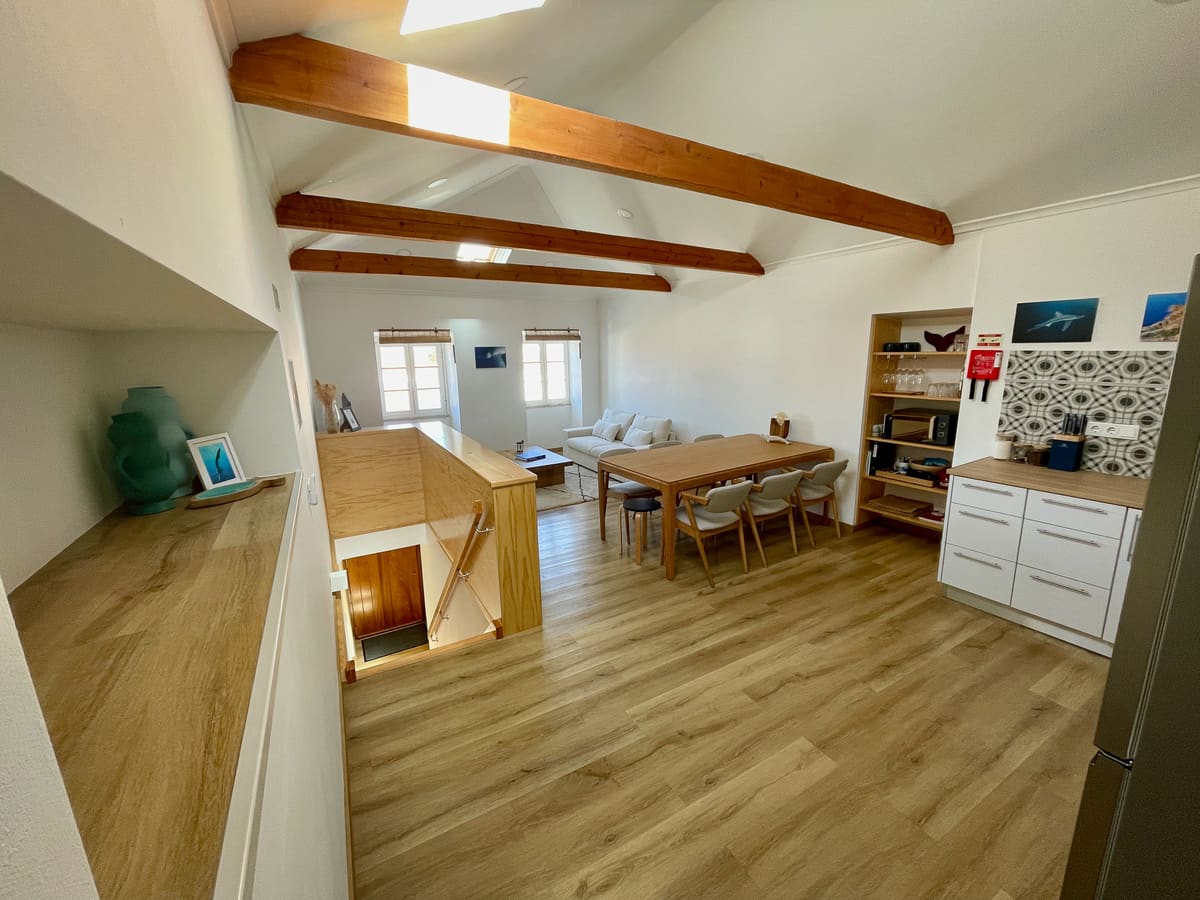Casa Tarapacana open-plan living, dining, and kitchen area with wooden beams