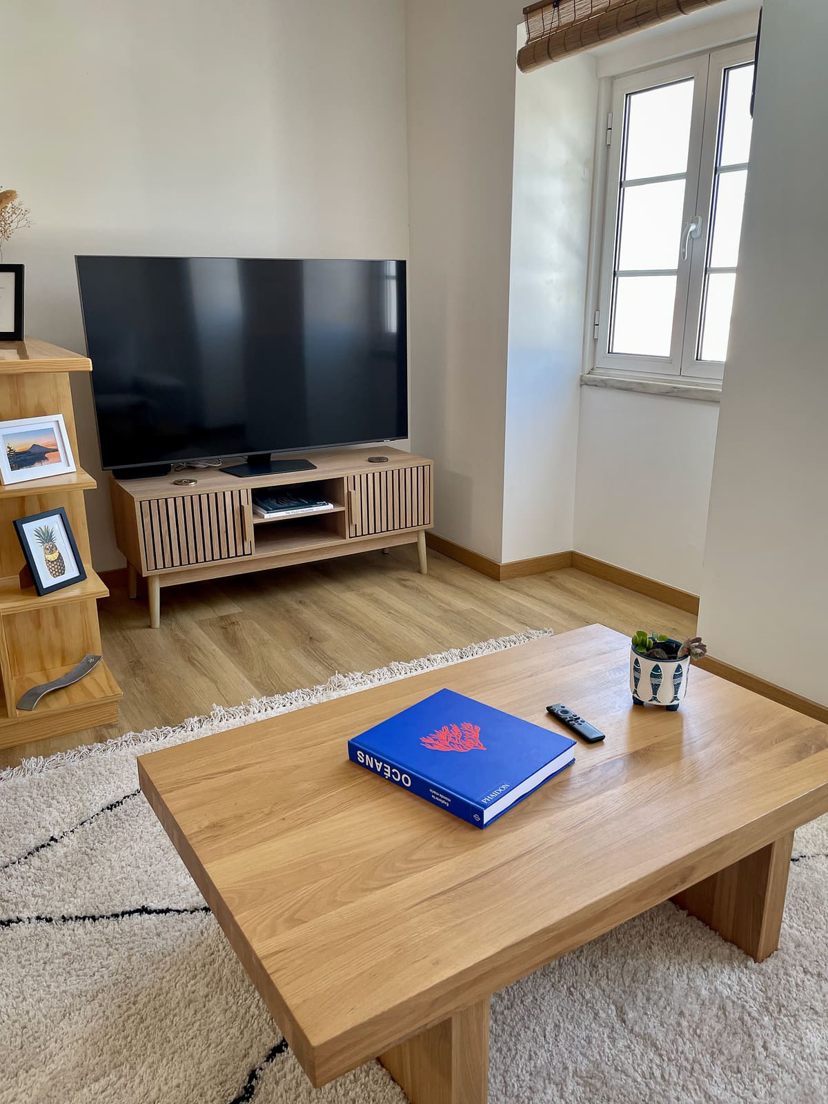 TV lounge at Casa Tarapacana with wall-mounted television and wooden console